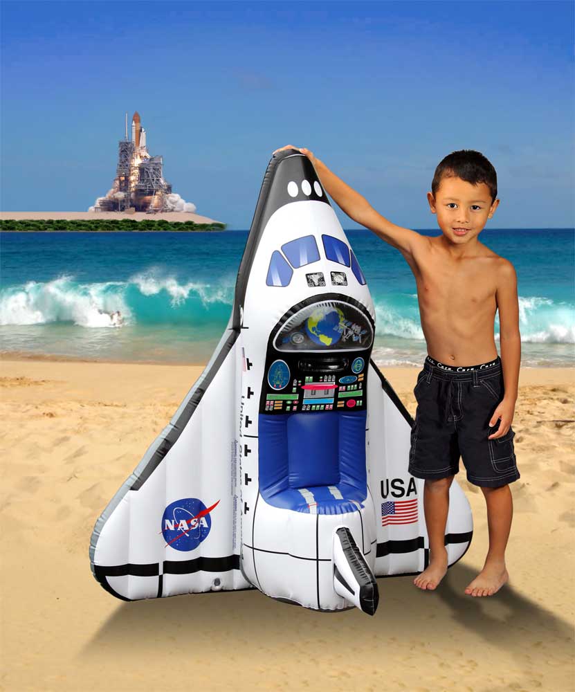 Kid holding inflatable space shuttle next to him.